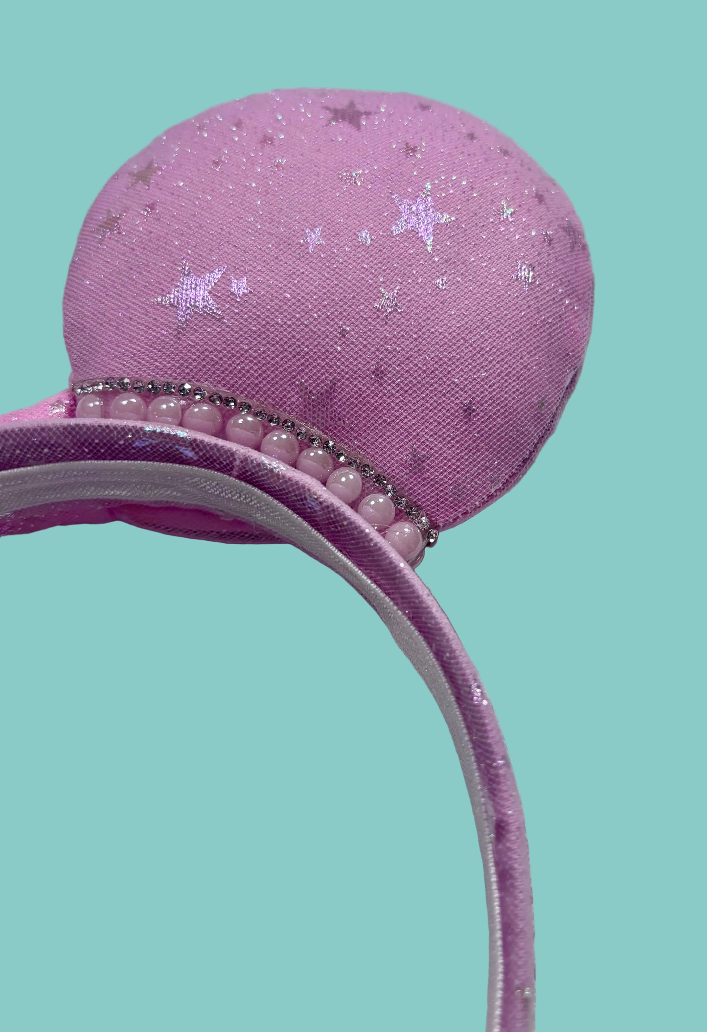 close up of pink mouse ears and rhinestone trim.