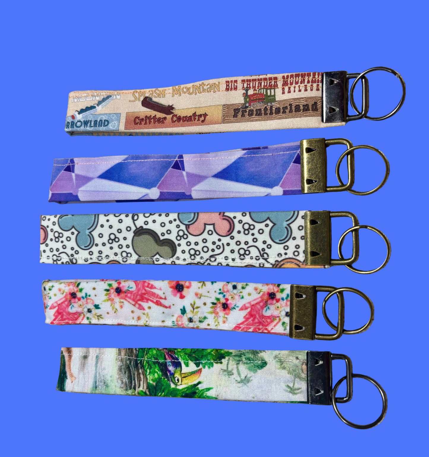 Five colorful keychain wristlets with different patterns inspired by Magic Kingdom. Back sides of keychains.