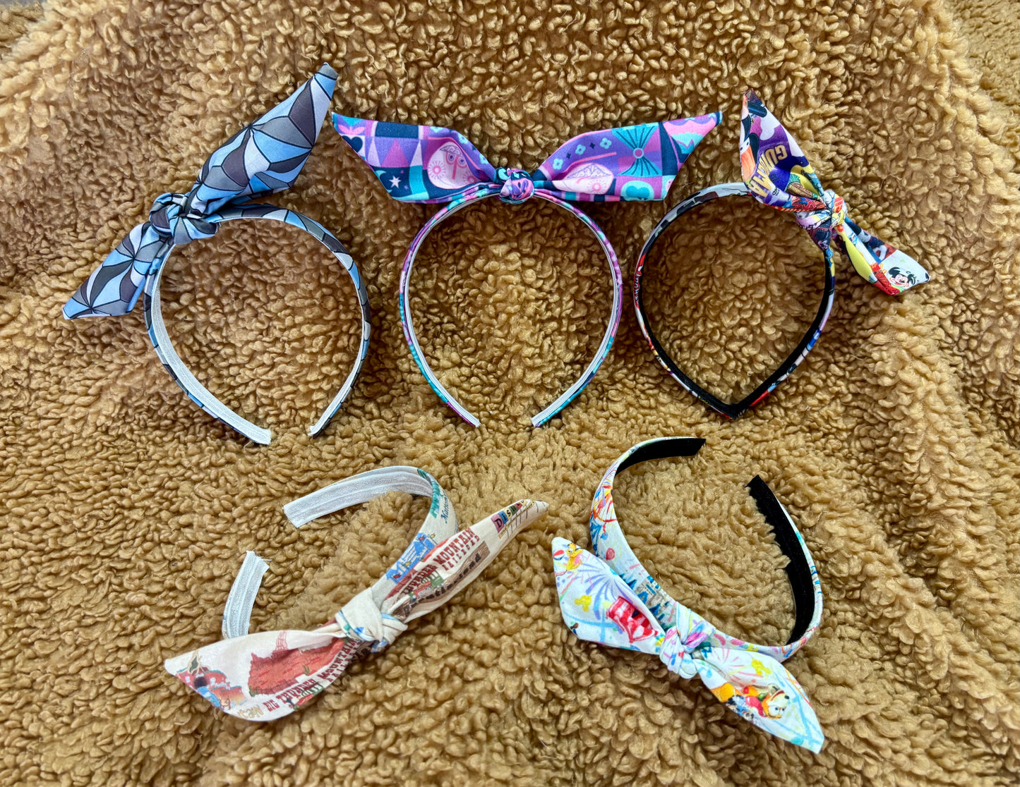 view of all five twisted headbands on a brown furry background.