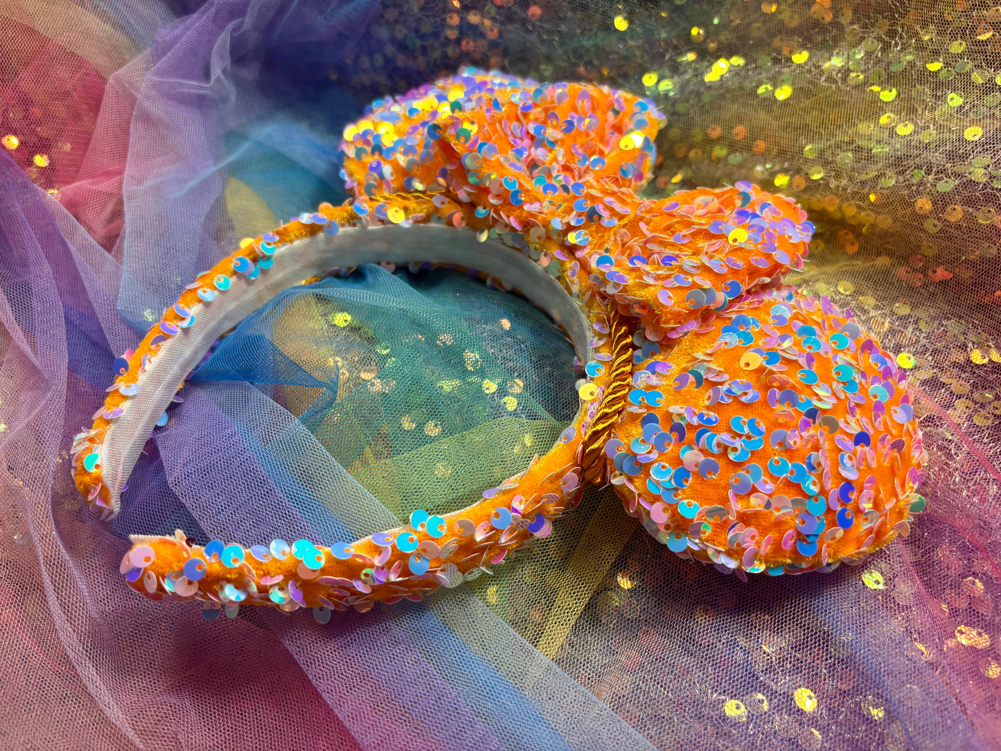 Colorful sequined headband with bow on a glittery background. Handmade and ready to ship.