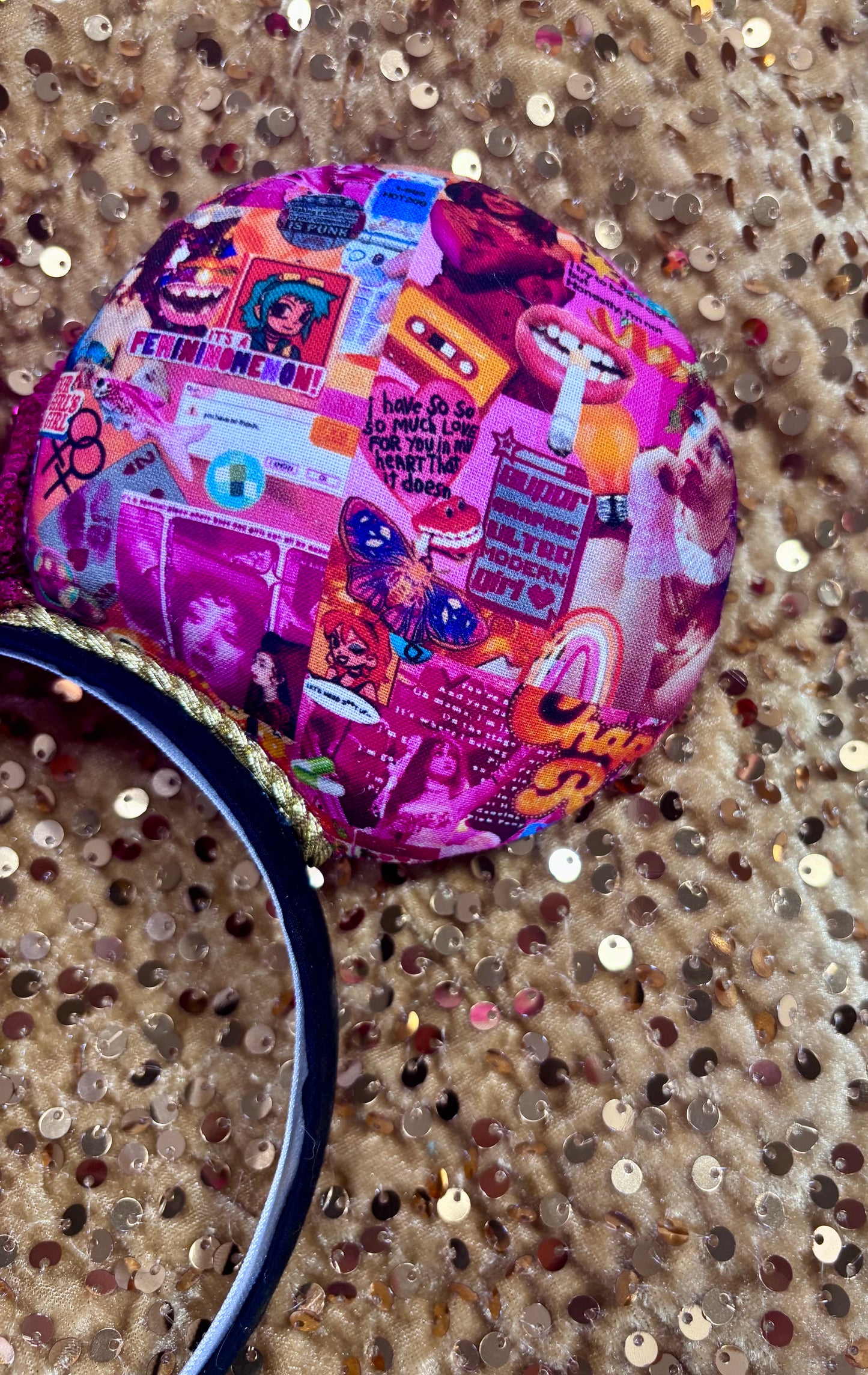 Handmade and ready to ship Colorful Chappell inspired Mouse ears with a hot pink bow on a headband against a gold sequin background.