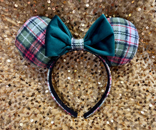 Green Plaid mouse ears with a green velvet bow. Shown against a blurred lights background