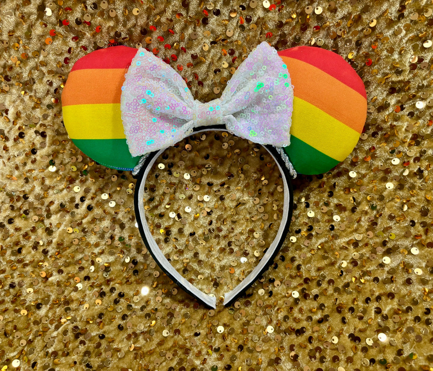 Handmade and ready to ship Pride Mouse ears with a white iridescent sequin bow with silver twisted trim and on a black universal sized headband.