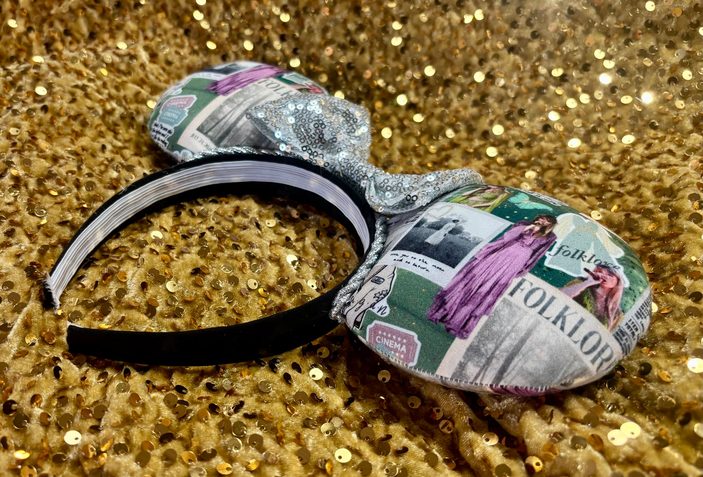 Headband with folklore inspired fabric ears shown on a glittery gold background