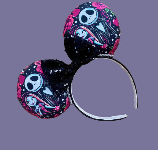 Handmade and ready to ship. NBC themed mouse ears with fabric on both sides of the ears on a black headband with silver twisted trim and a black sequin bow.