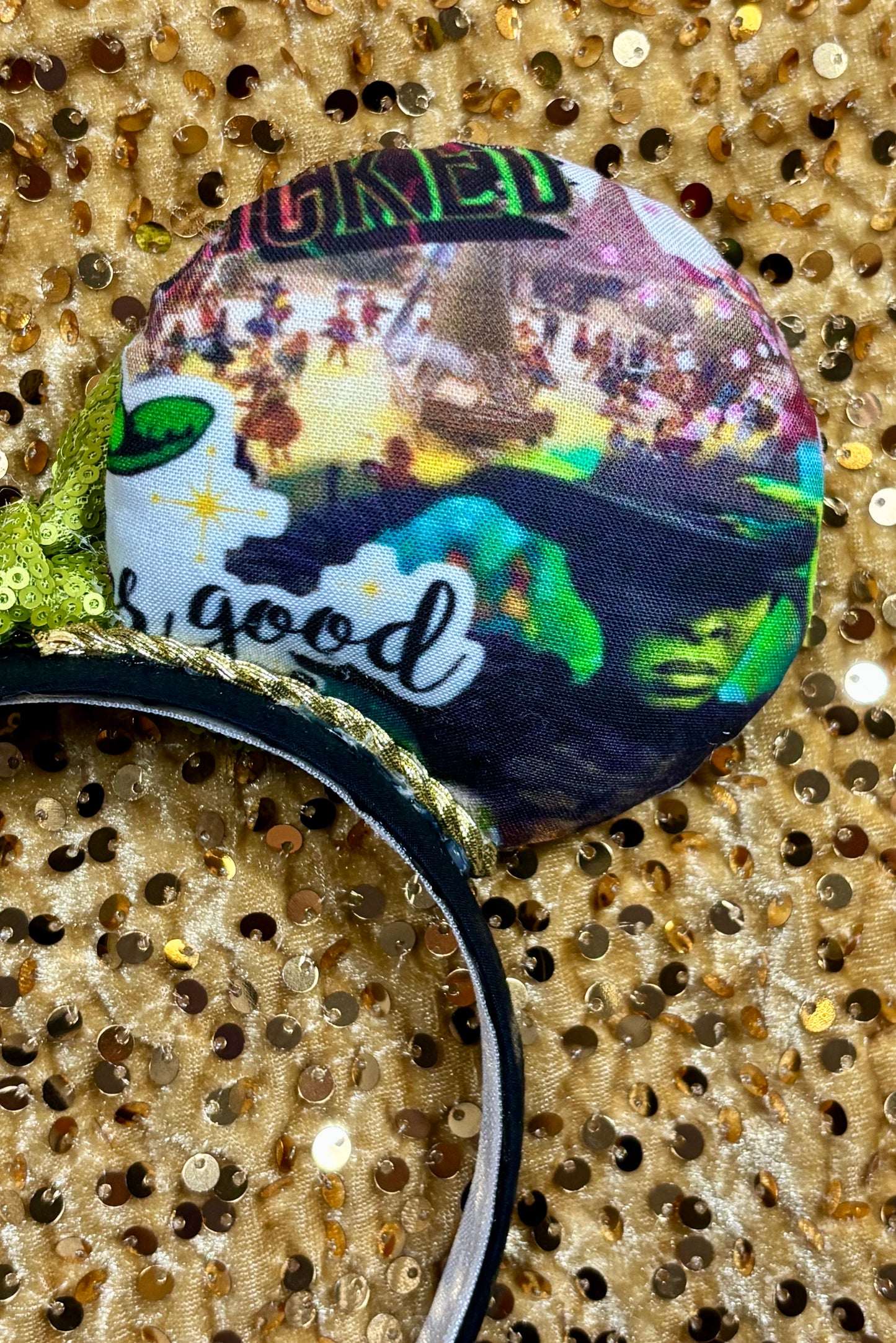 Wicked Inspired Handmade Mouse ears with a lime green sequin bow on a gold background
