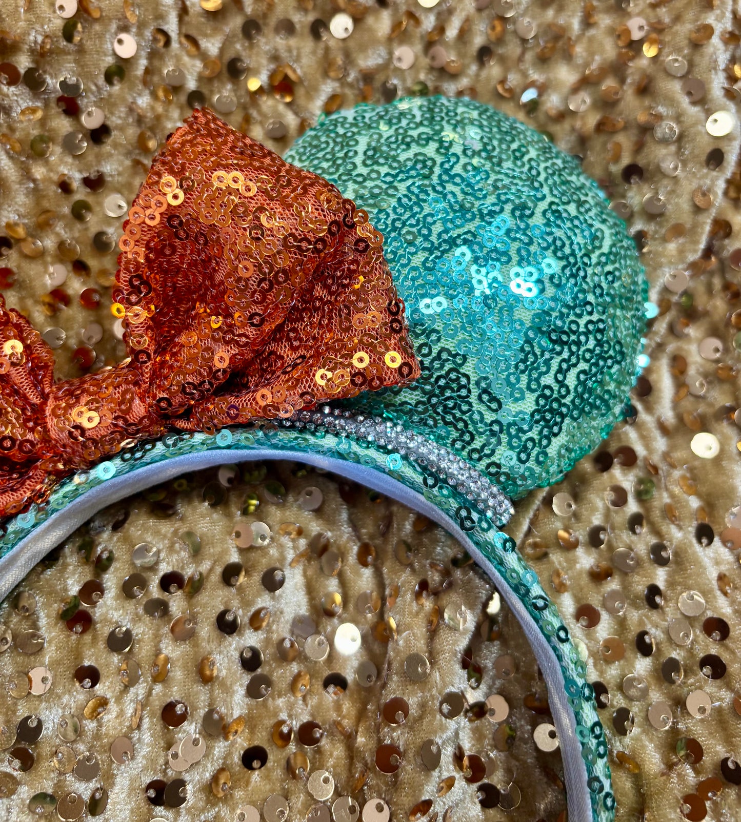 Close-up of a decorative headband with sequins on a glittery background