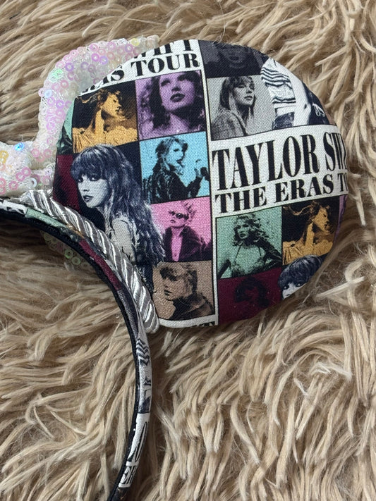 A close-up of a round fabric-covered headband featuring a collage print of TS photos and text