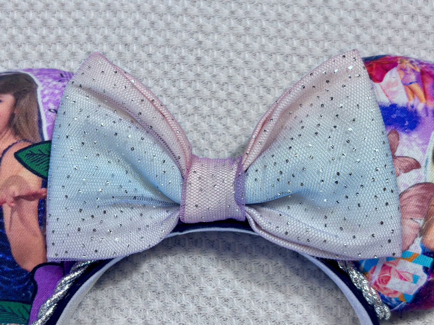 close up of the new bow. Handmade and ready to ship TS Mouse ears with a new beautiful sewn tulle bow with sparkles on it. Of course, you can still request any bow in sequin if you prefer and I will attach it. Shown on a gold sequin background.