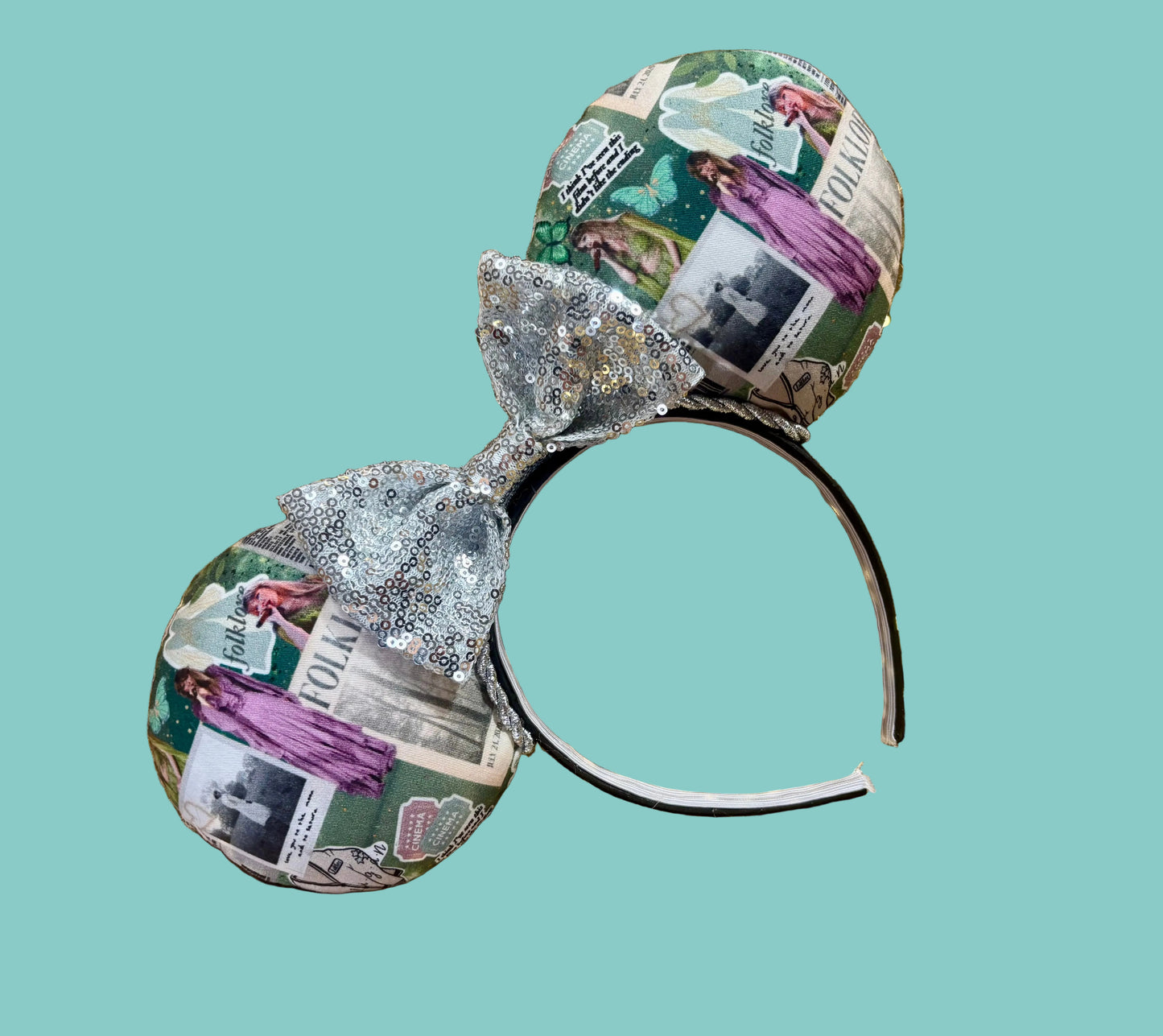 Handmade and ready to ship Folklore Inspired Mouse ears with Tay images from that era on the front and back of mouse ears shown with a silver sequin bow. The headband has a black poly cotton fabric and is a universal sized headband.