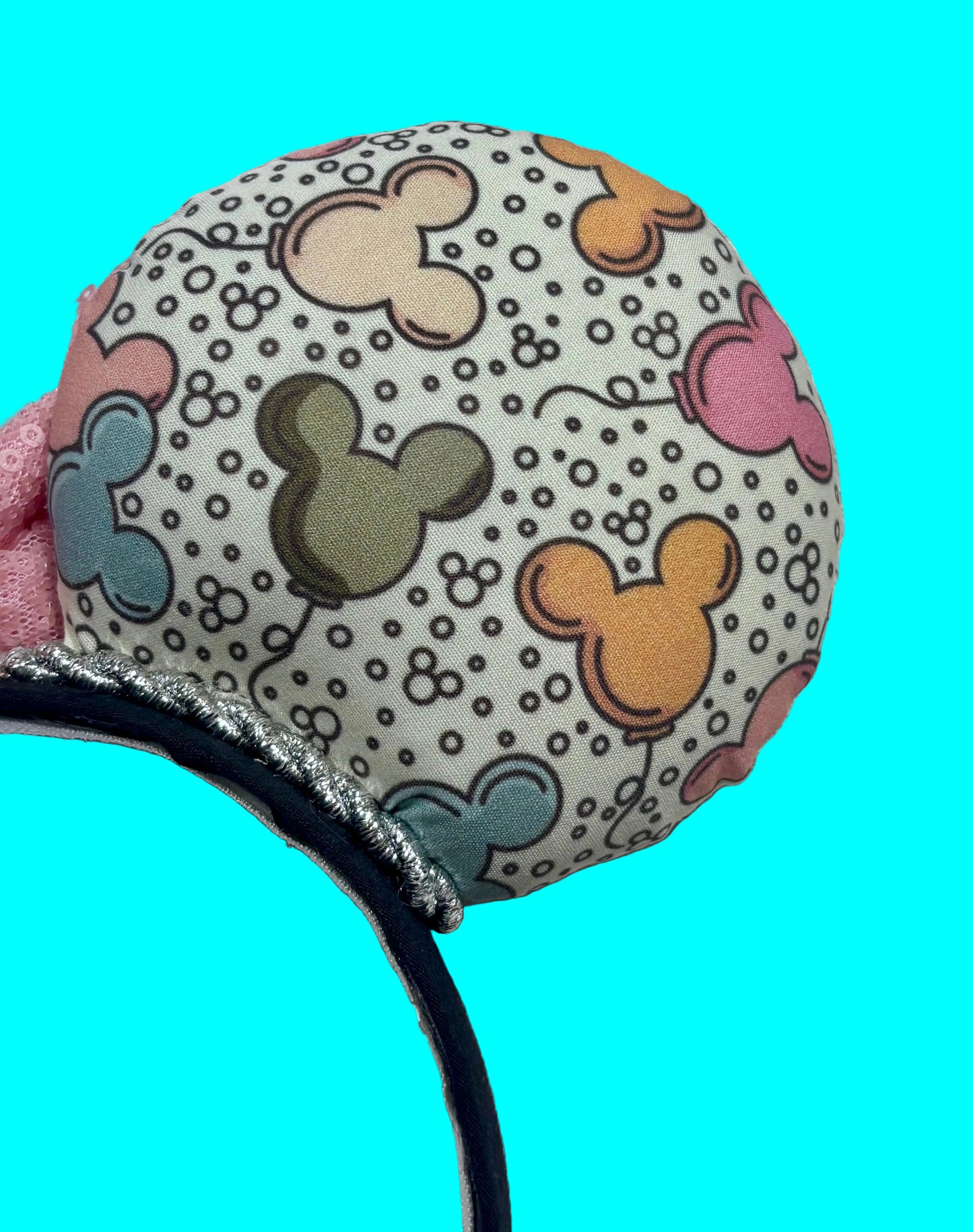 Close up of back right mouse ear. Handmade and ready to ship Mouse ears with mouse balloon fabric with a light pink sequin bow. Perfect for Main Street.