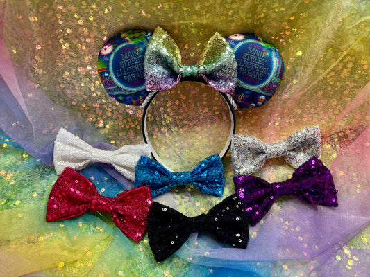 Handmade and ready to ship Main St. Electric Parade Inspired Mouse ears with a rainbow sequin bow with silver twisted trim and on a black universal sized headband. Different sequin bows shown in case you would prefer a different color.