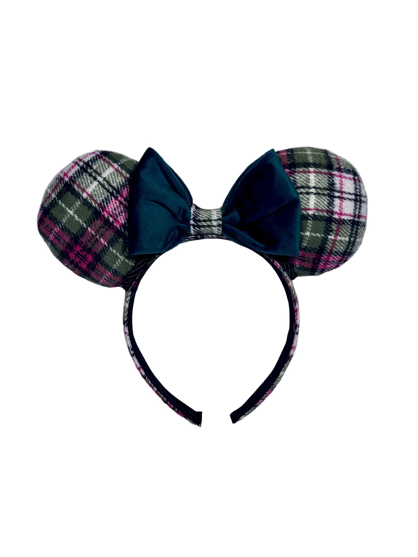 Plaid mouse ears with a green velvet bow on a textured gray background