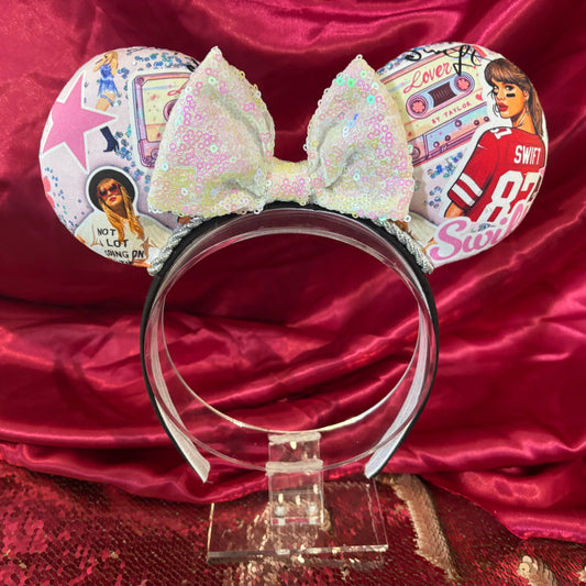 Handmade and ready to ship So High School Tay Inspired mouse Ears. The fabric is on the ears front and back with silver twisted trim along the inner ears. A white iridescent sequin bow, but you can write me a note in your order if you prefer a different color. The set is on a black poly cotton universal sized headband.