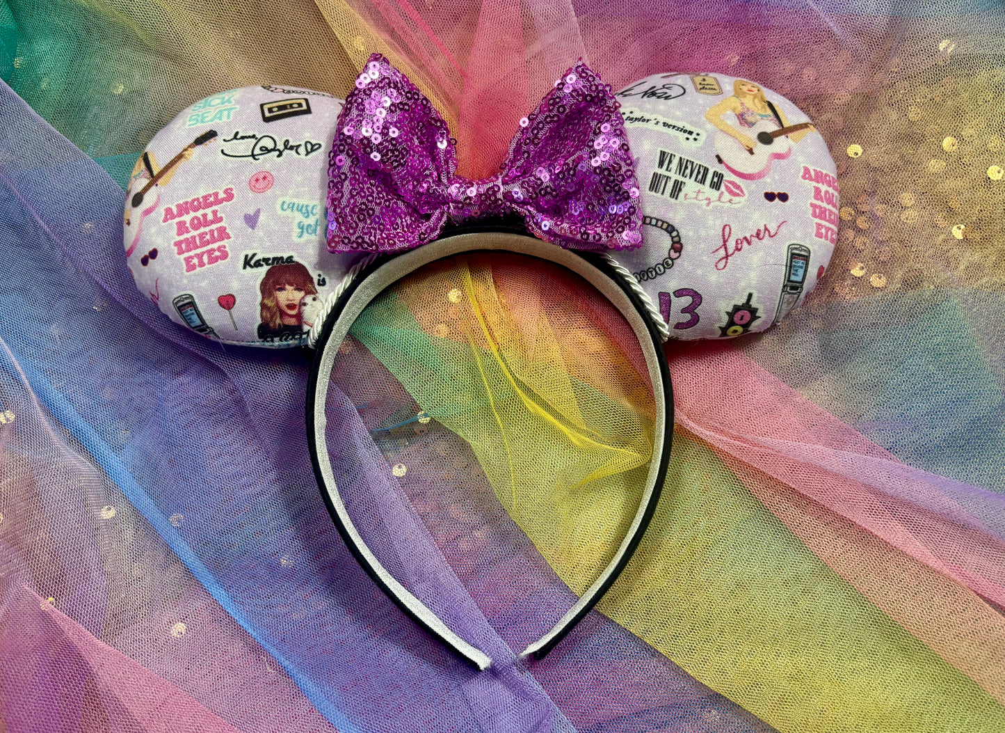 Handmade and ready to ship Lilac Mouse ears with Tay inspired images on the front and back of mouse ears with a lavender purple bow on a rainbow background