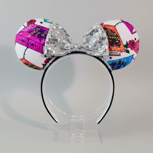 Handmade and ready to ship custom and unique ears that have images from the books on the mouse ears front and back. Silver twisted trim is along the inner ears with a silver sequin bow on a black poly cotton universal sized headband.
