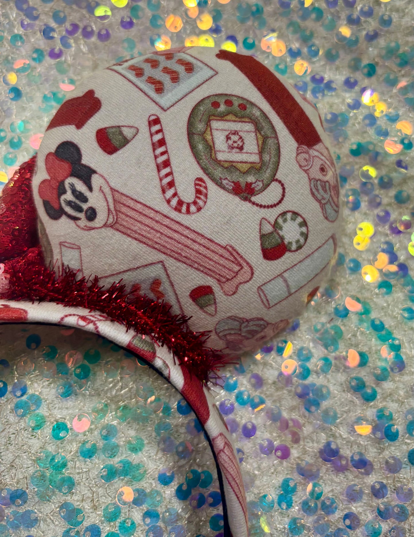 Handmade and ready to ship Back view of other side of ear. Stocking Stuffers Mouse ears with a beautiful red with a light pink middle sequin bow. Of course, you can request any bow in sequins if you prefer and I will attach it. the red trim is like garland along the inner ears and the headband is universal sized and has the same Stocking Stuffer fabric on it as well.