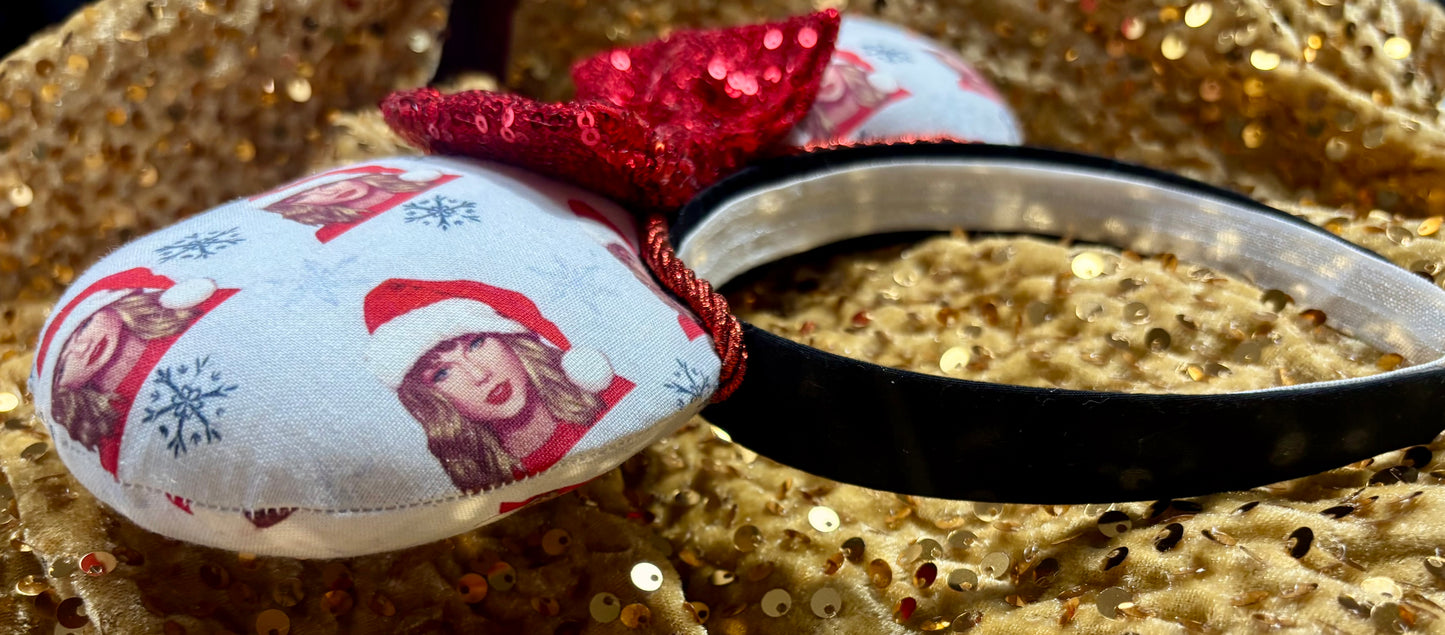 Mouse ear headband with red bow and character print on a glittery background