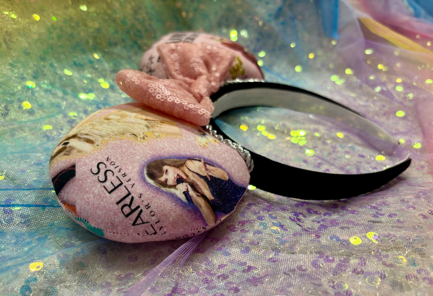 Images of Tay on pink fabric from the Eras concert on front, and back. These are handmade and ready to ship mouse ears with a light pink sequin bow. Shown on a rainbow background