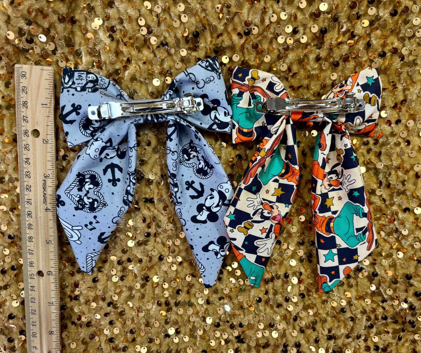 Back view of the bows and the barrette backing with a ruler for size.
