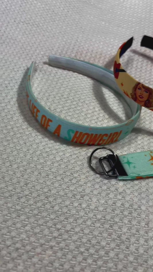 Set of three handmade and ready to ship colorful headbands and two keychains on a white background