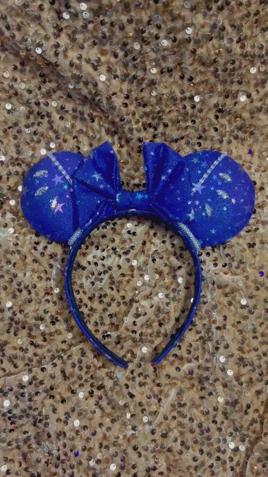 Blue glittery mouse ears headband with star accents and rhinestones on the ears with rhinestone trim.