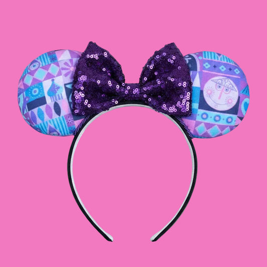 Handmade and ready to ship. Small world inspired Mouse ears. The fabric is on the fabric front and back with purple twisted trim and a purple sequin bow on a universal sized black headband.