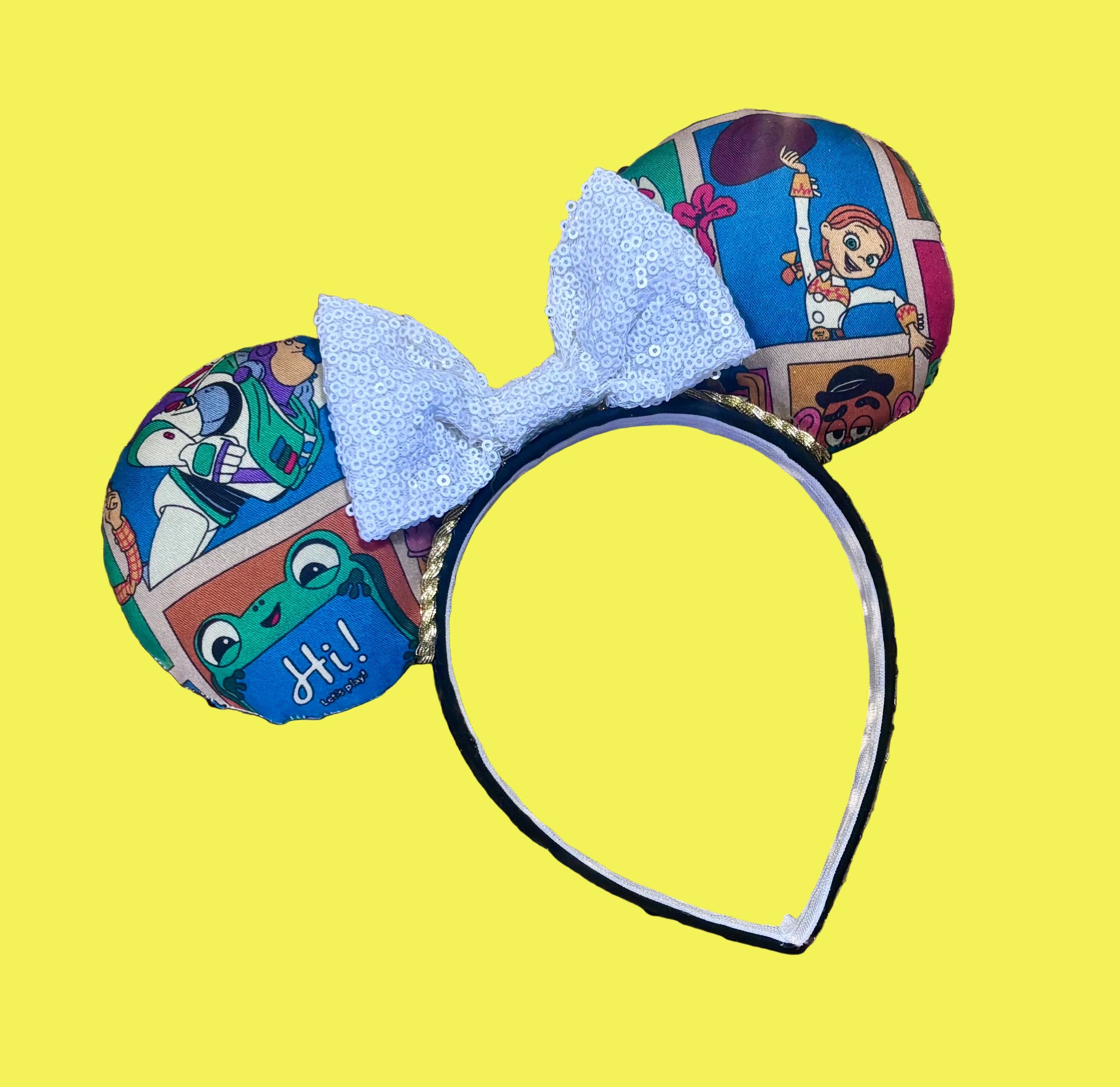 Handmade and ready to ship TS5 Inspired mouse ears. The character fabric is on the front and the back. On a universal sized black poly fabric headband. With a white sequin bow.