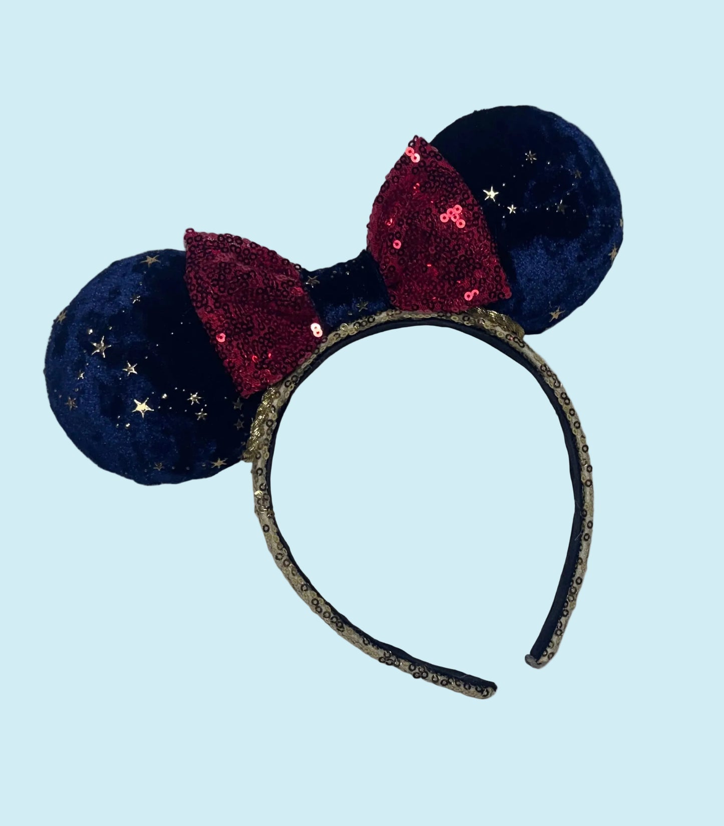 Handmade and ready to ship Navy Velvet fabric with gold stars and red sequin bow mouse ear headband on a gold sequin universal sized headband. 