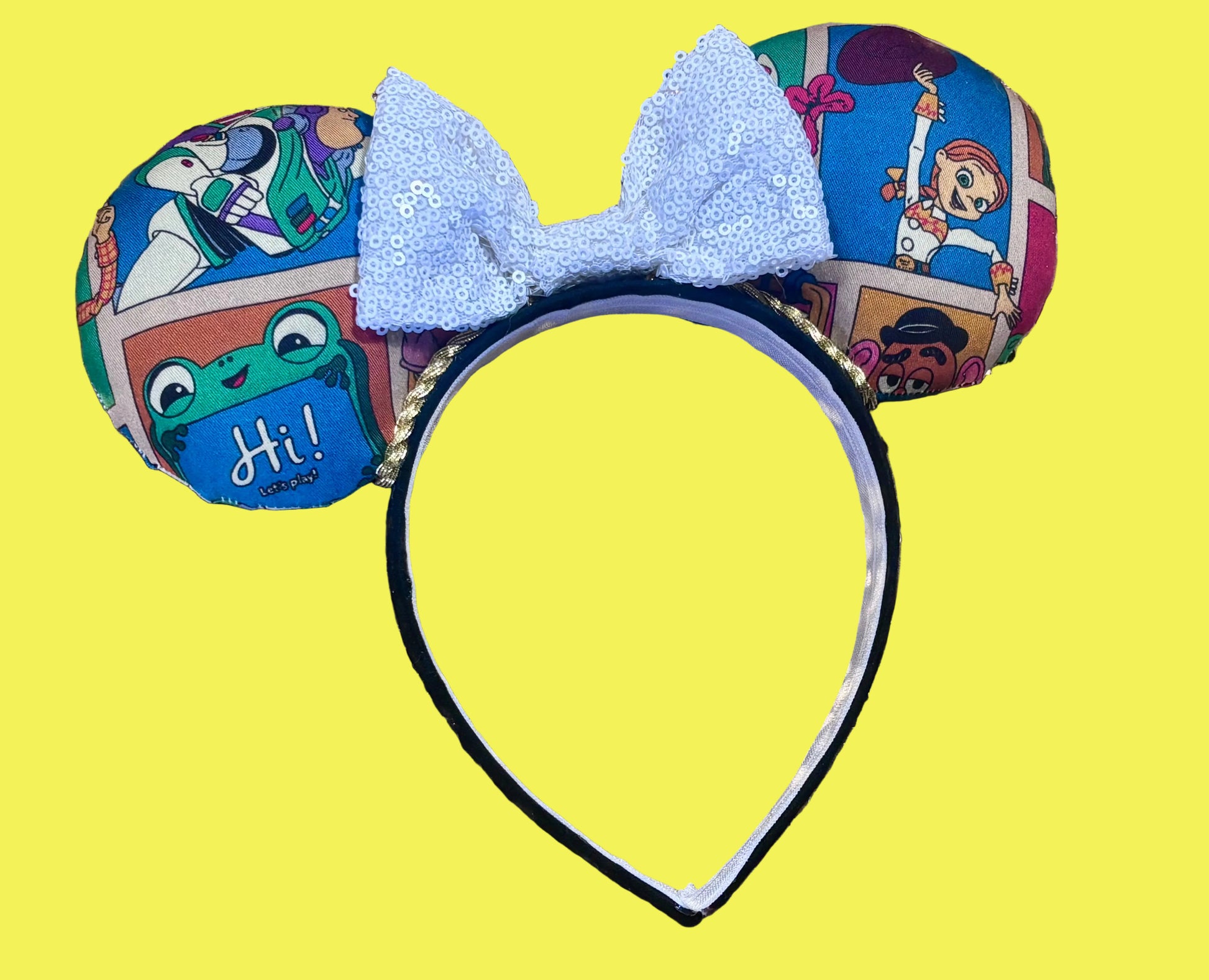 Handmade and ready to ship TS5 Inspired mouse ears. The character fabric is on the front and the back. On a universal sized black poly fabric headband. With a white sequin bow.