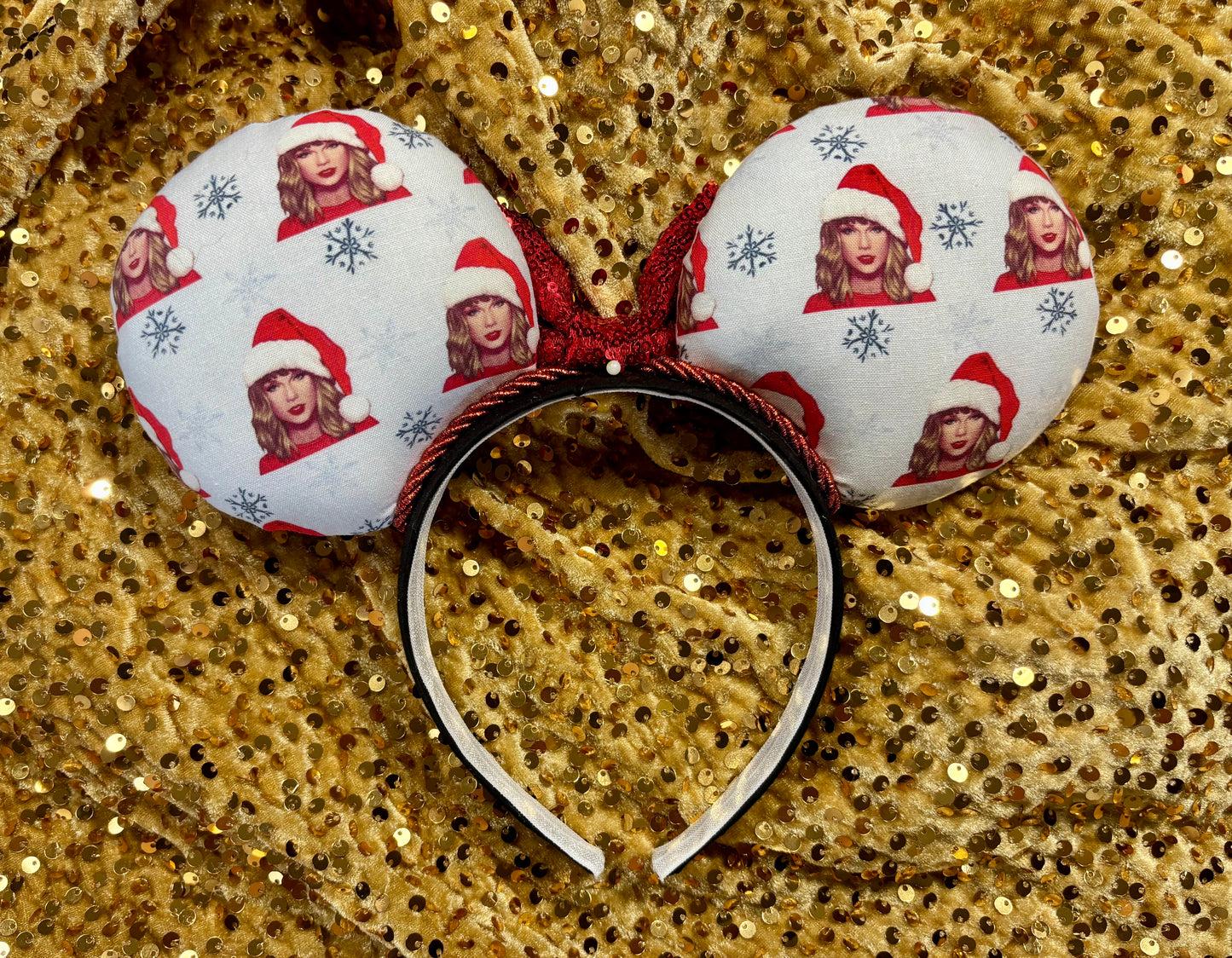 Decorative headband with festive design on a gold sequin background
