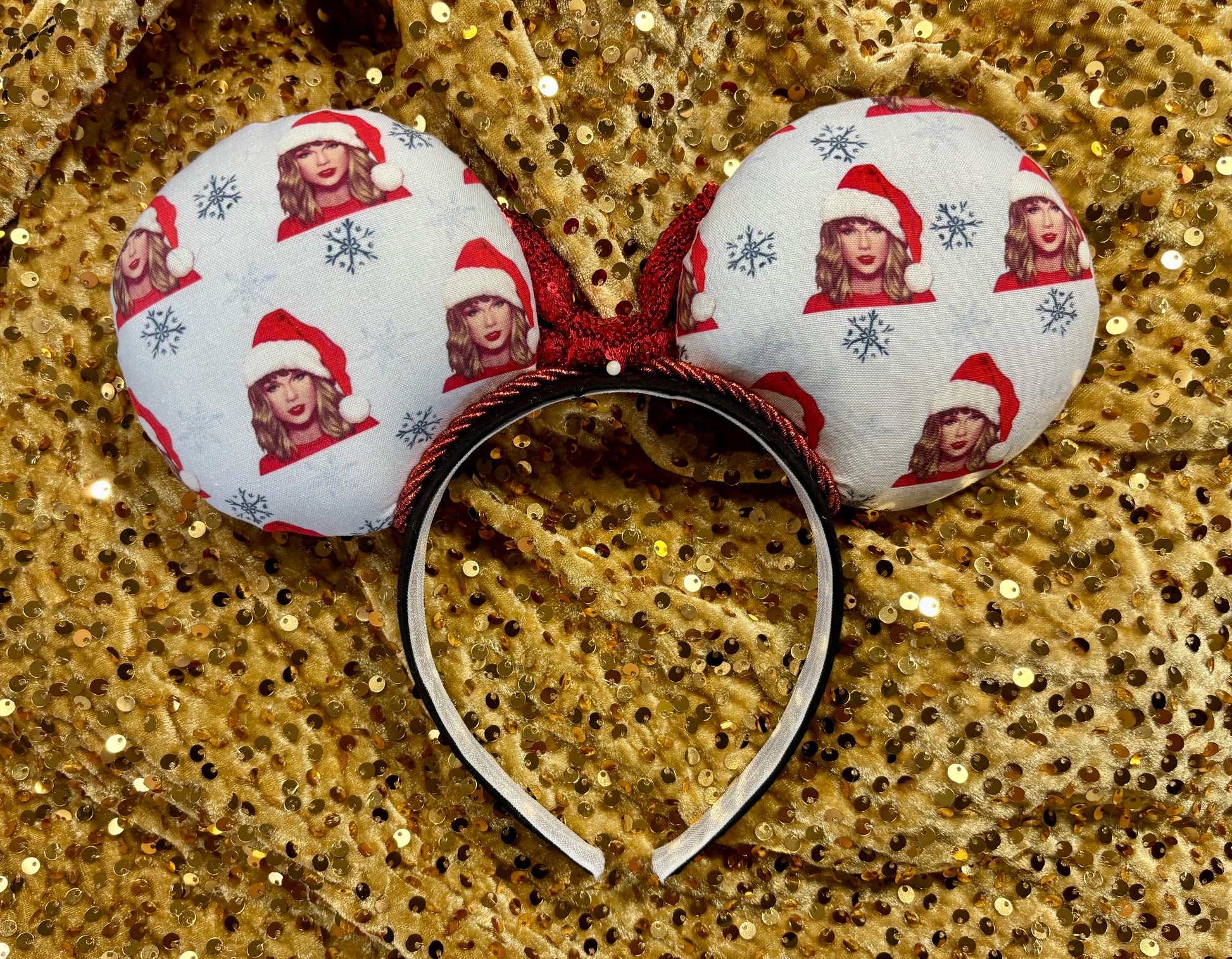 Decorative headband with festive design on a gold sequin background