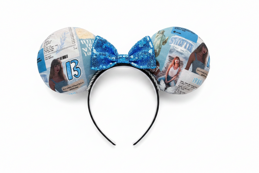 Mouse ears with a blue bow and newspaper print on a white background