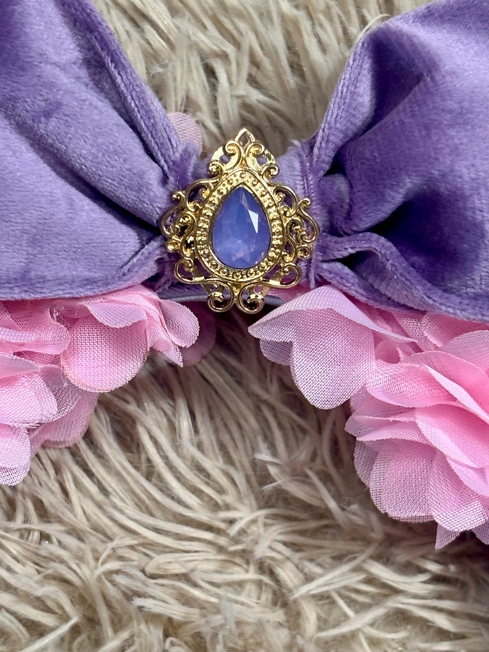 close up of the purple embellishment on the bow middle. 