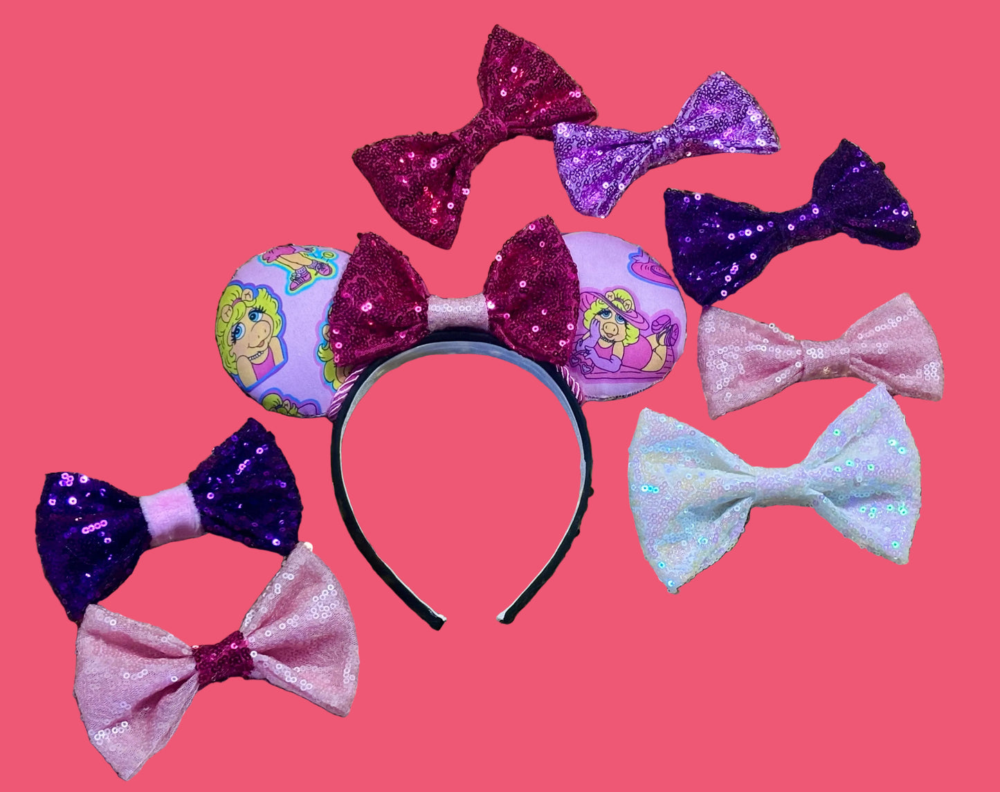 Handmade and ready to ship Piggy mouse ears. Miss Piggy fabric is on the front and the back. On a universal sized black poly fabric headband. Shown with many bow options in case you don't want the default purple and pink middle bow. 