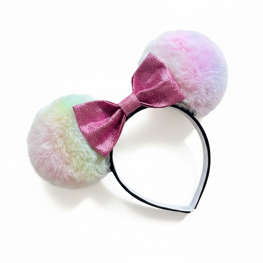 Pastel-colored mouse ear headband with a pink bow on a white background