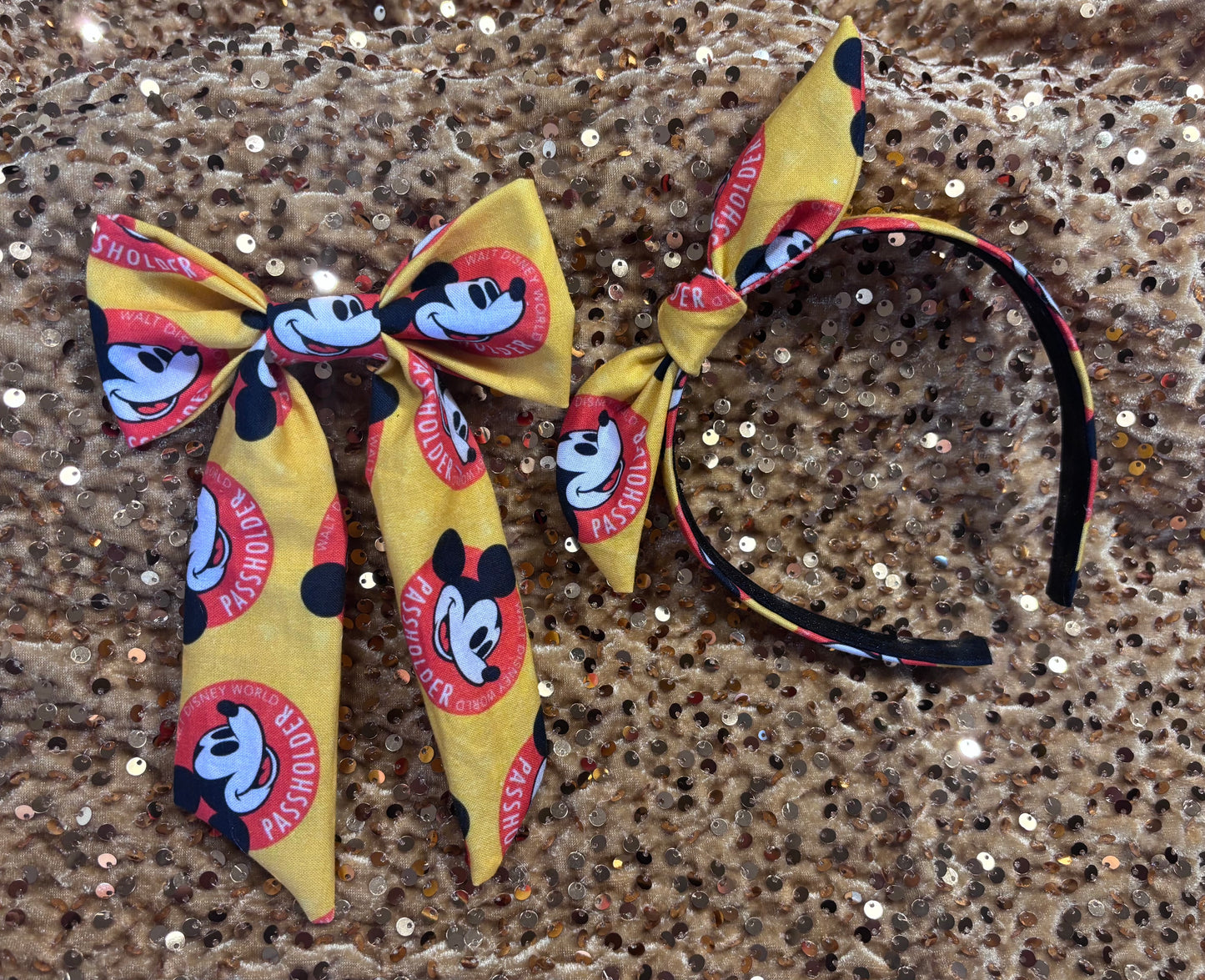 Handmade and ready to ship hair bow and twisted bow headband with cartoon character design with AP logo.