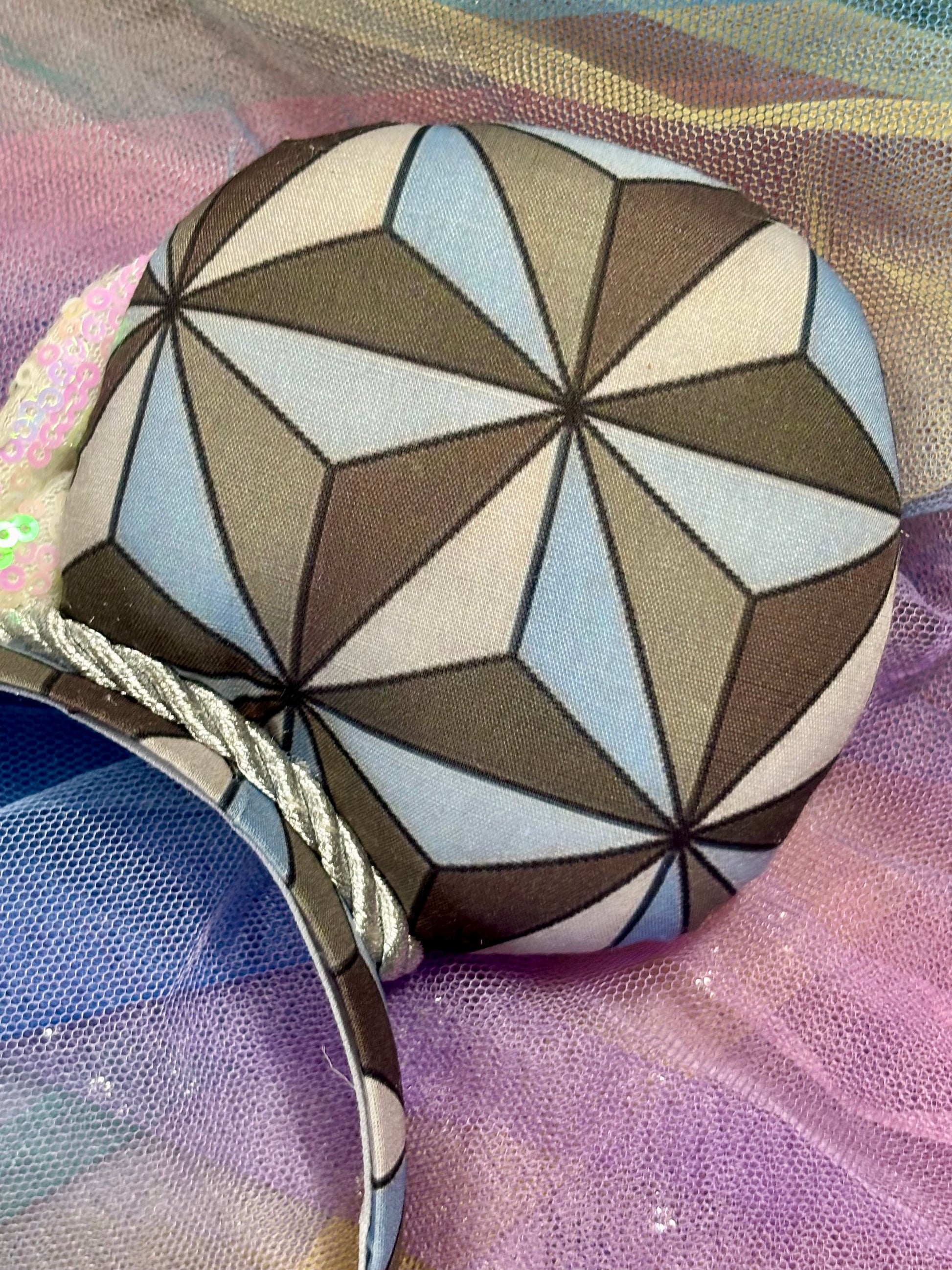 Back right view of the mouse ears. Shown on a rainbow background.