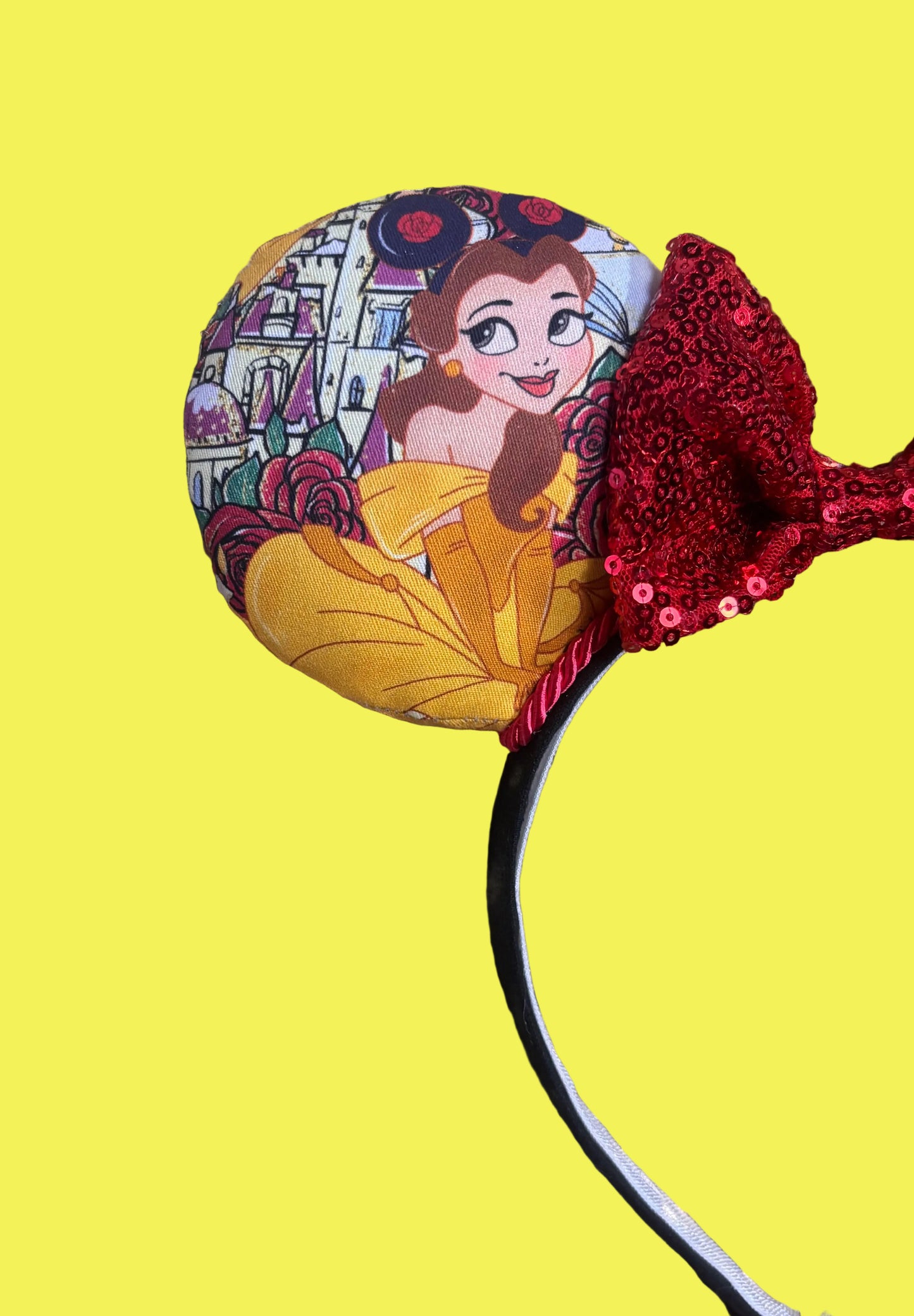 Front closeup of ear. Belle from Beauty and the Beast-themed headband with Belle wearing mouse ears with red twisted trim and a red sequin bow. Handmade and ready to ship. 