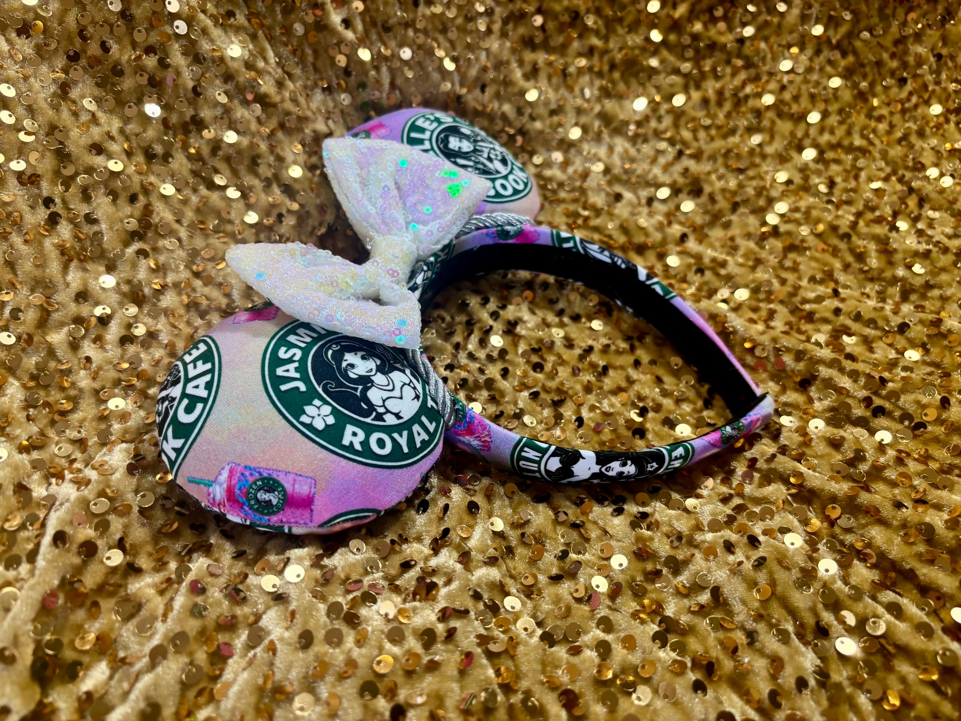 Handmade and ready to ship custom ears with popular coffee themed with princesses on fabric. White iridescent bow and silver twisted trim on a universal sized headband with matching design as the mouse ears.
