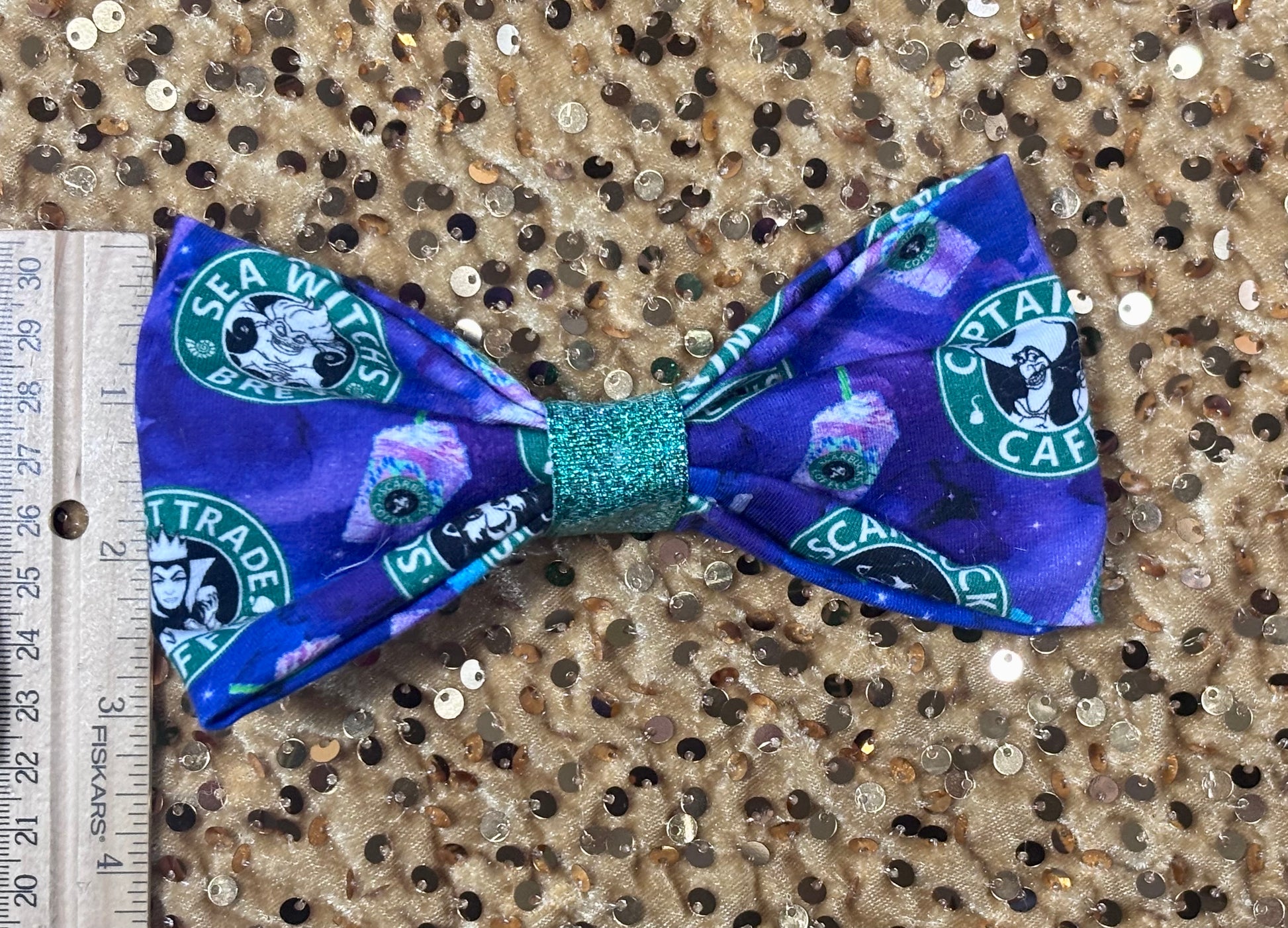 Handmade and ready to ship hairbows in a famous beloved coffee company's image but villains on the bow. Shown with a ruler for reference.
