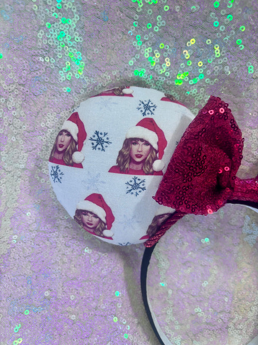 Decorative headband with red bow and festive design on a glittery background