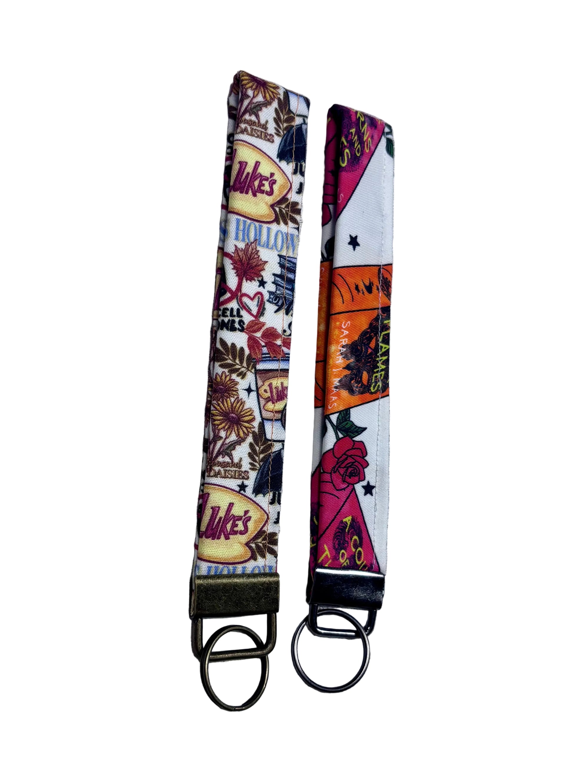 Two keychains with colorful designs on a textured gray background