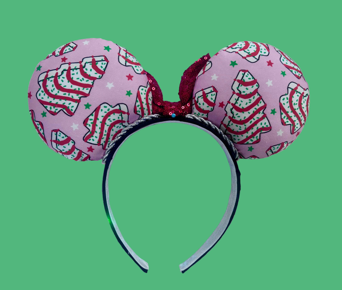 Back side of mouse ears. Handmade and ready to ship. Decorative headband with pink fabric and Christmas tree cake inspired fabric on the ears featuring a red sequin bow.