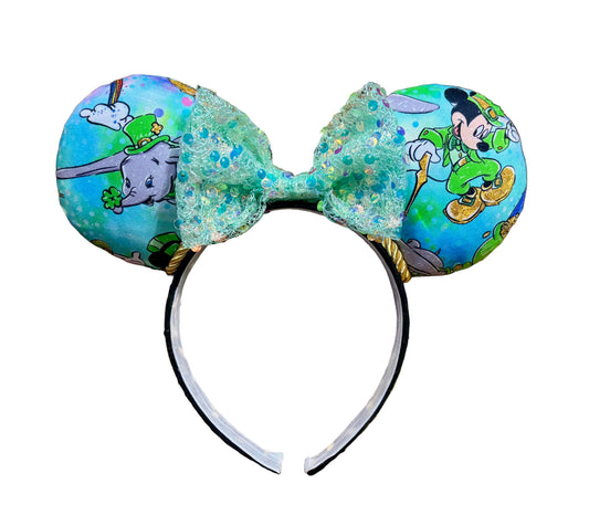 Decorative St. Patrick's Day themed headband with cartoon characters on a white background
