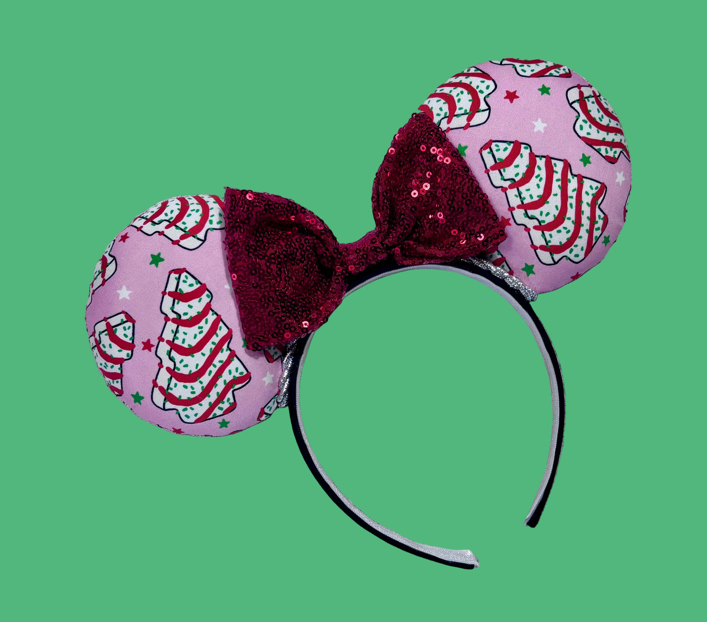 Handmade and ready to ship. Decorative headband with pink fabric and Christmas tree cake inspired fabric on the ears featuring a red sequin bow.
