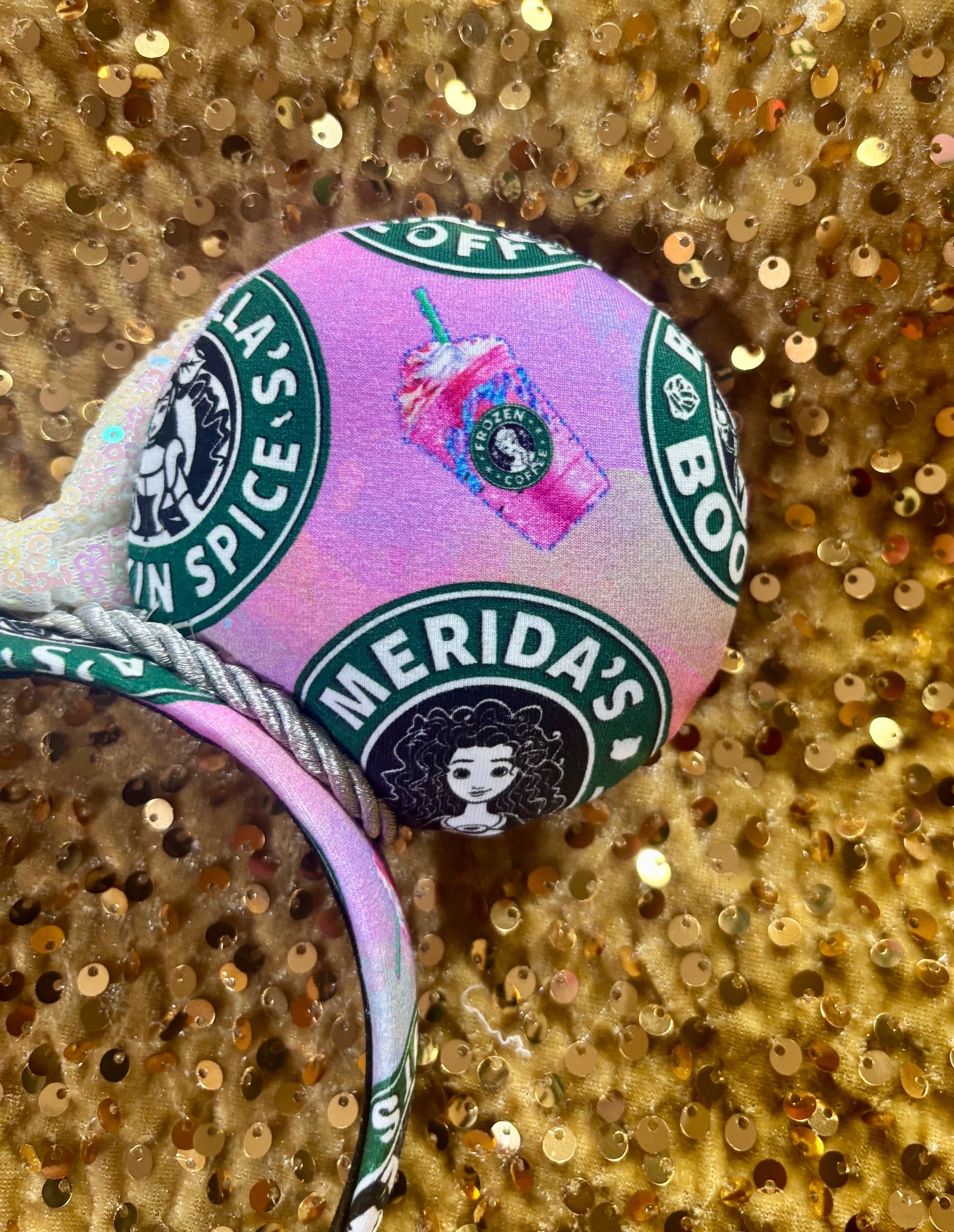 Handmade and ready to ship custom ears with popular coffee themed with princesses on fabric. White iridescent bow and silver twisted trim on a universal sized headband with matching design as the mouse ears. Back view showing Merida and a frap.