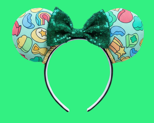 Handmade and ready to ship custom ears with lucky marshmallows on the fabric front and back with a green sequin bow and gold trim on a universal sized black poly cotton headband.
