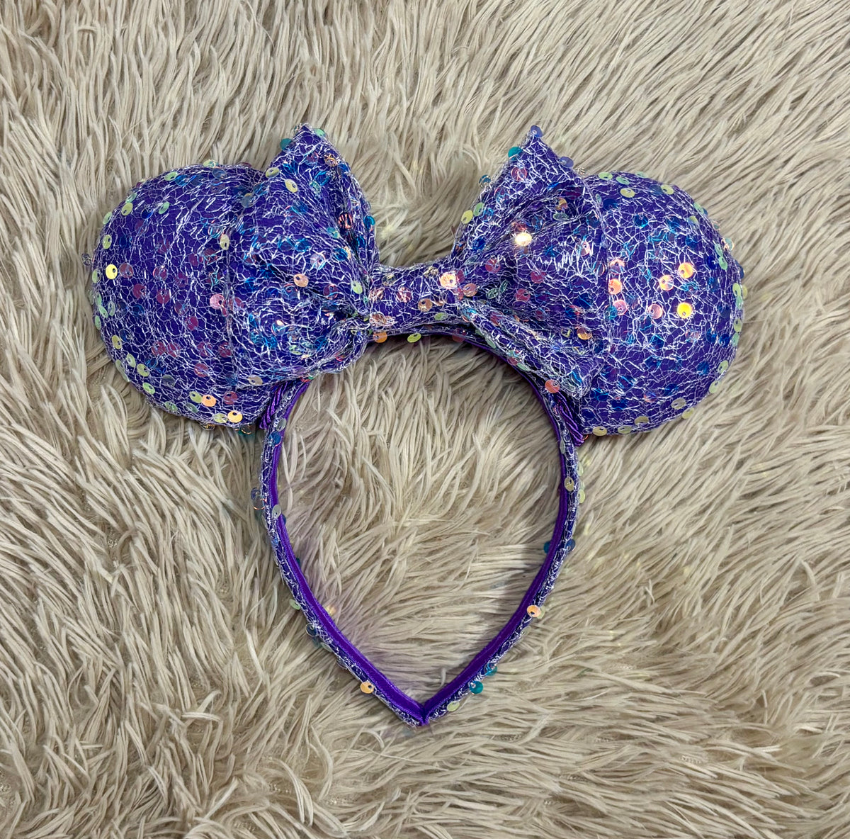A purple iridescent sequined headband with two large mouse shaped ears. Handmade and ready to ship.