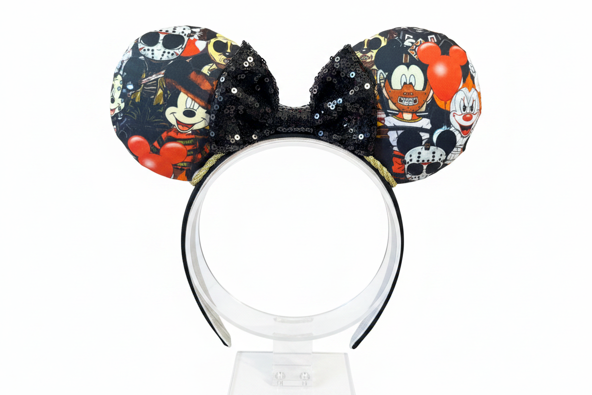 Handmade and ready to ship Halloween Horror Toons Mouse ears with the fabric is on the ears, front and back and a black sequin print bow and gold twisted trim. The headband is a universal sized headband and has black poly cotton fabric on it.